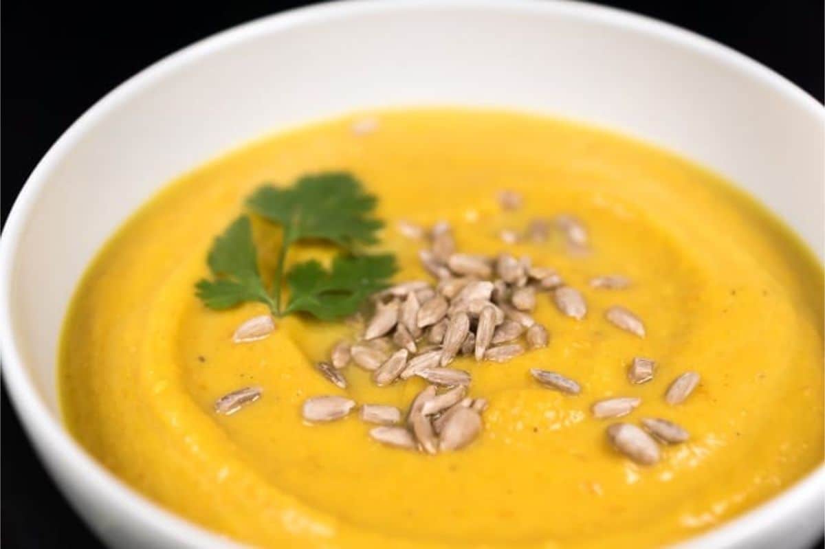 Creamy Carrot and Sweet Potato Soup carrot and sweet potato soup, topped with sunflower seeds