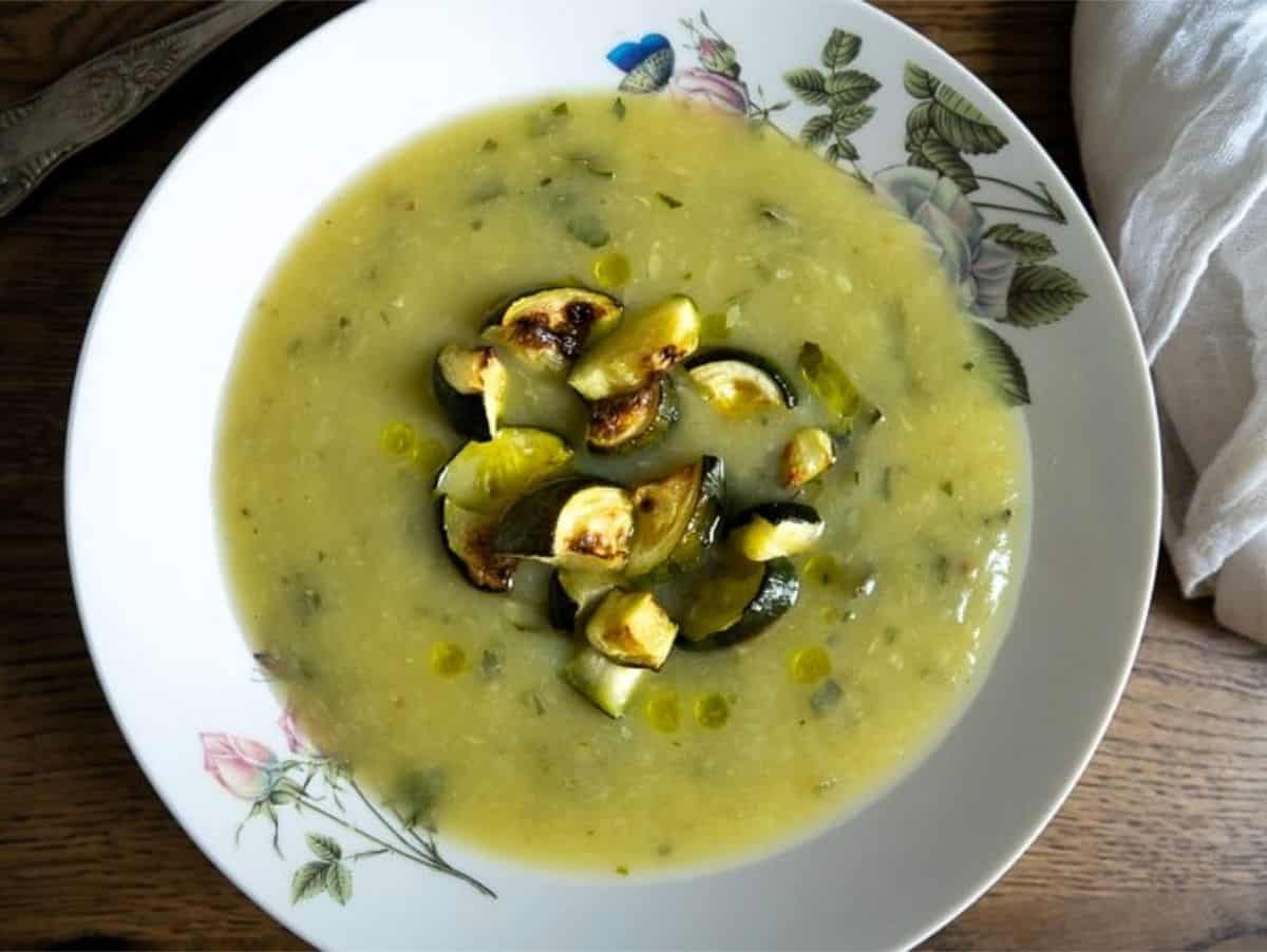 Creamy roasted courgette soup topped with roasted courgette pieces