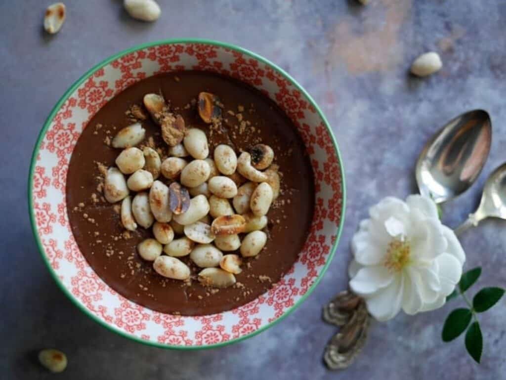 Opulent chocolate peanut butter pudding with toasted peanuts