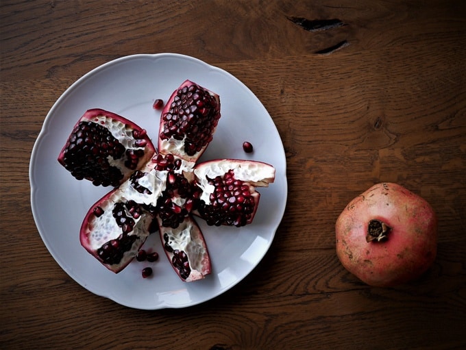 A pomegranate cut open, providing a visual guide on how to open a pomegranate.