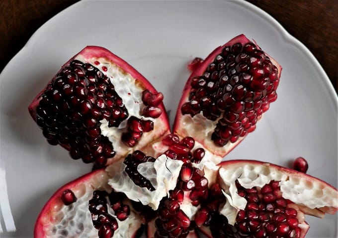 A pomegranate cut open (top view), providing a visual guide on how to open a pomegranate.