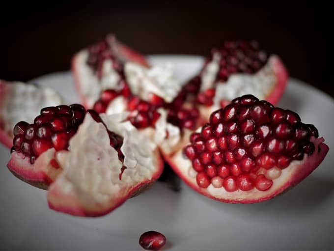 A pomegranate cut open (side view), providing a visual guide on how to open a pomegranate.