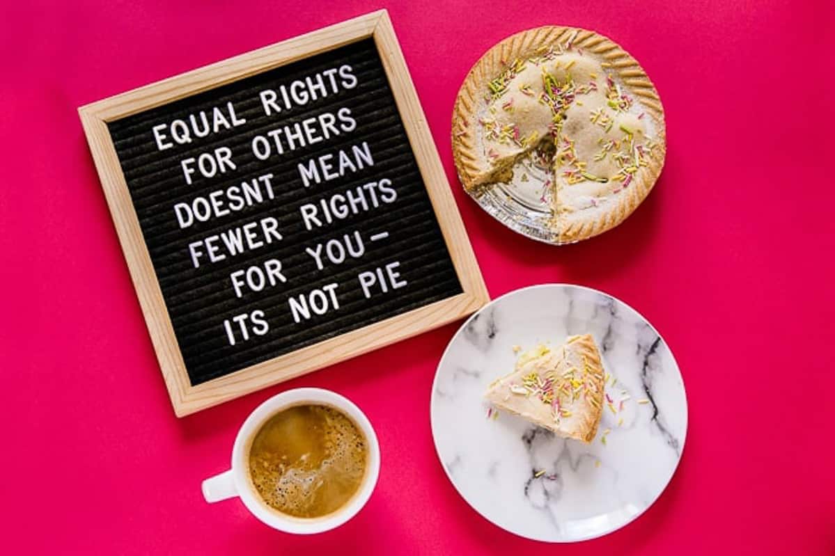 Cake and coffee with a board saying "Equal rights for others doesn't mean fewer rights for you - it's not pie." Donate to women's charities if you can, it will help promote equal rights.