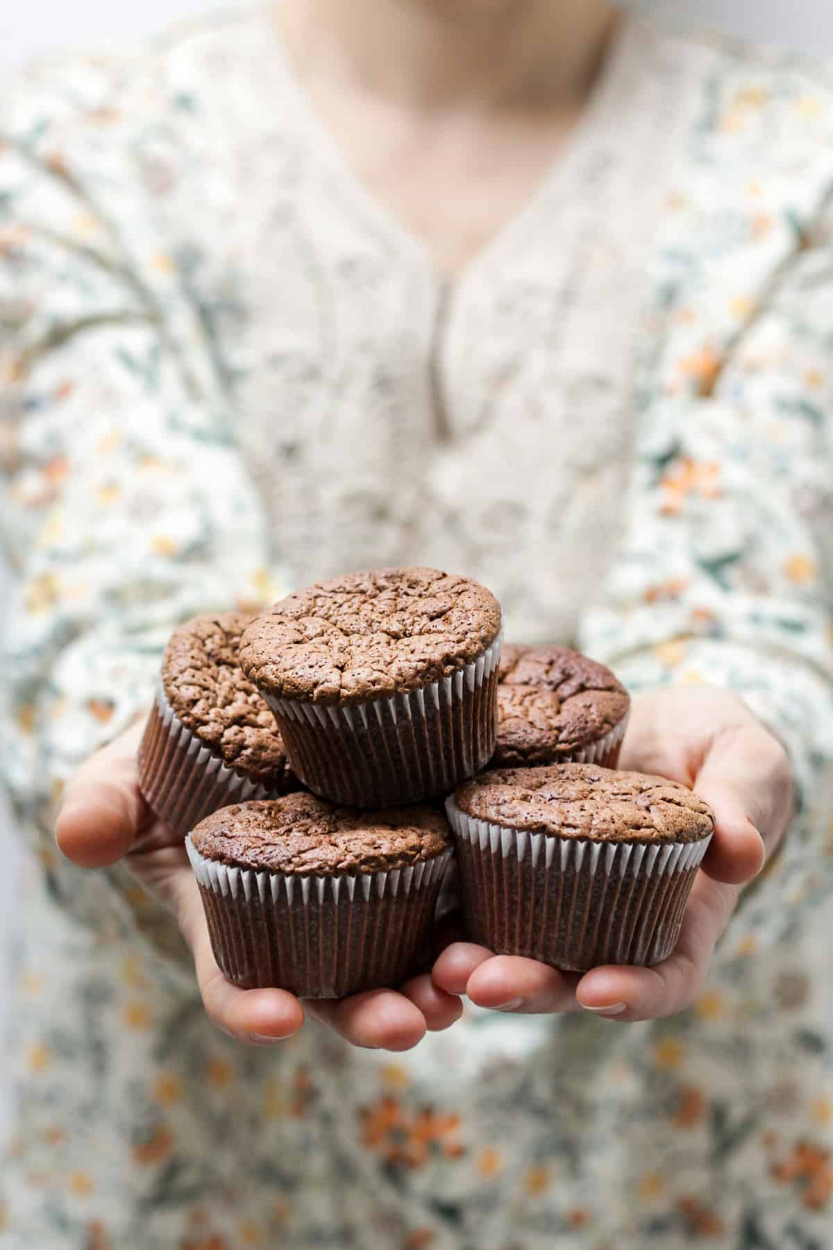 A woman offering chocolate muffins - might be a Marry Me recipe.